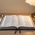 Open parallel Bible with multiple columns beside study notes and reading glasses